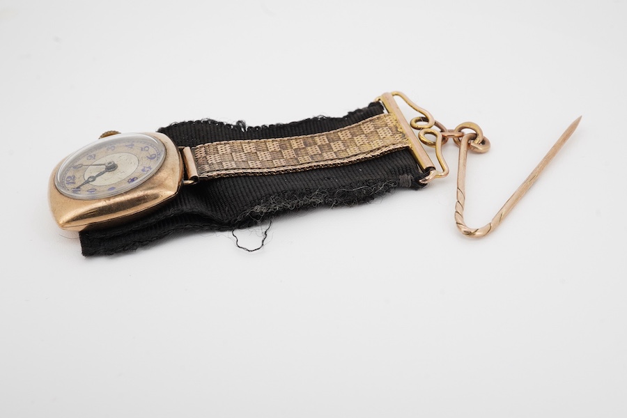 A lady's 9ct gold manual wind lapel watch, with blue enamelled Arabic dial and a 9ct mounted black sash suspension brooch, gross weight 15.5 grams. Condition poor to fair